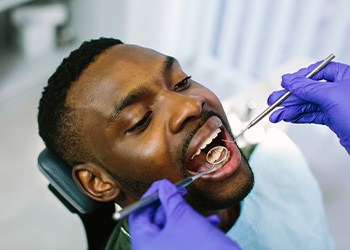 Dentist examining patient's teeth