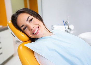 Woman smiling while sitting in treatment chair