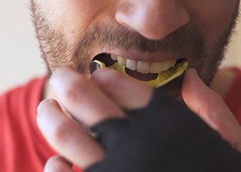 Man with yellow and black mouthguard