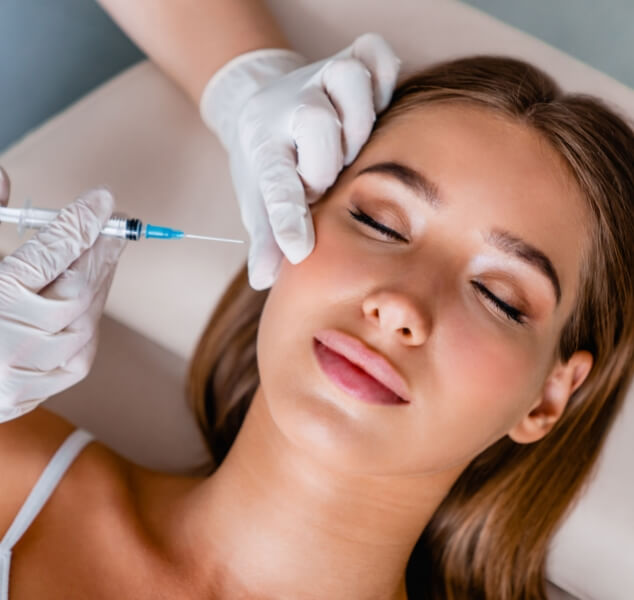 Woman receiving Botox injection in her cheek