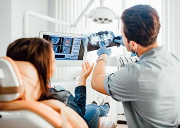 Dentist reviewing X-ray with patient