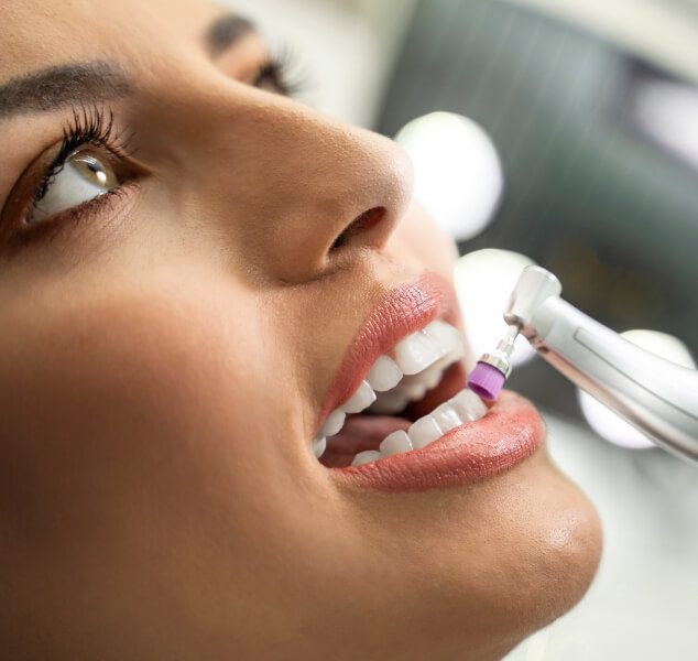 Woman having her teeth professionally cleaned during preventive dentistry checkup