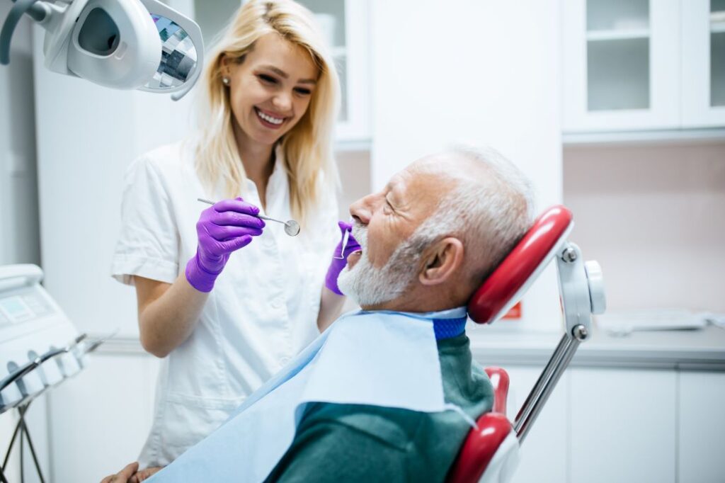 A man in a dental chair having a dental implant exam.